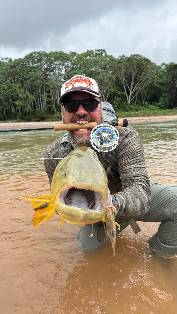 A dorado landed in muddy water on a Puglisi Sabalito pattern