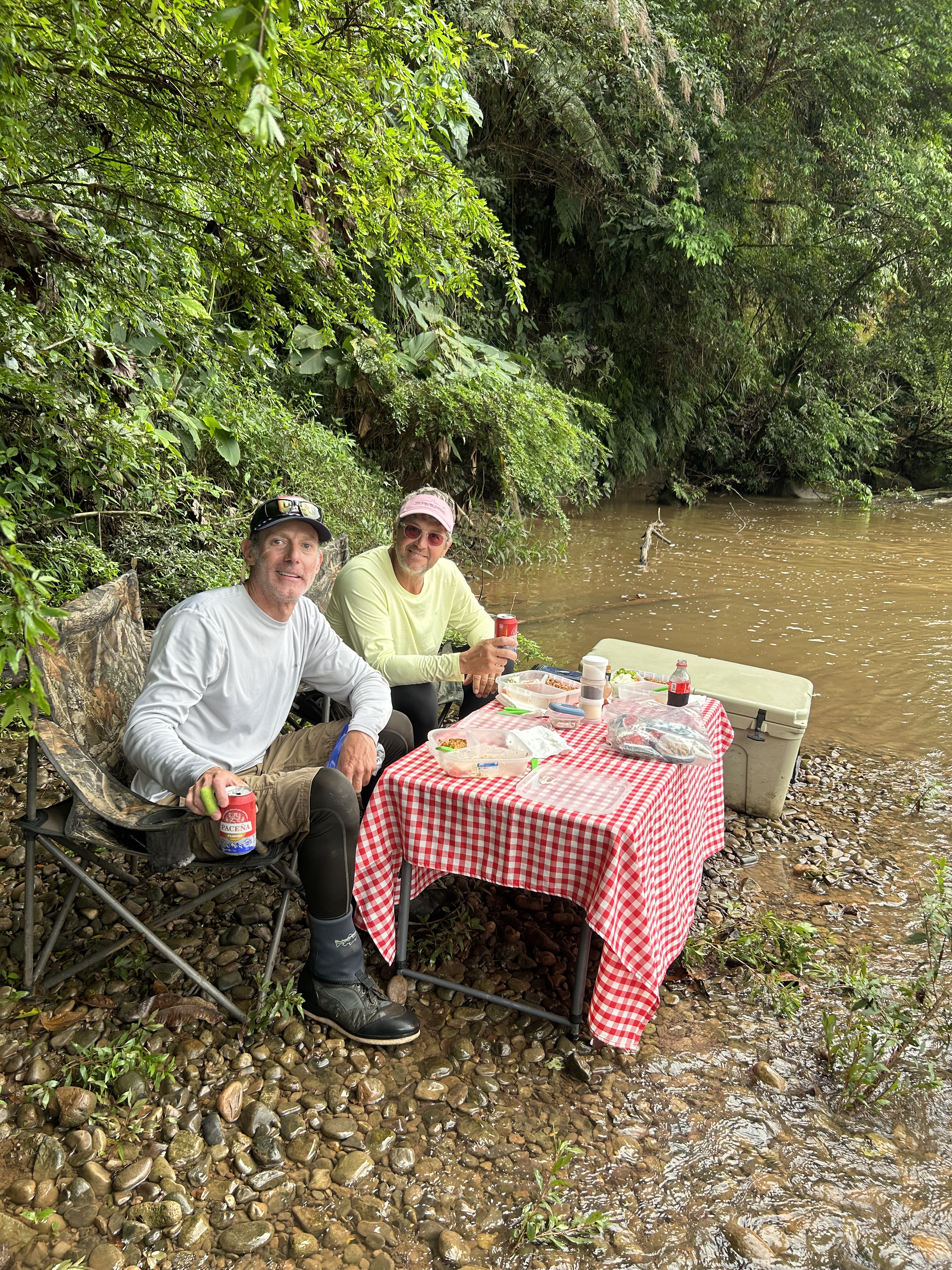 Two anglers taking lunch by the river