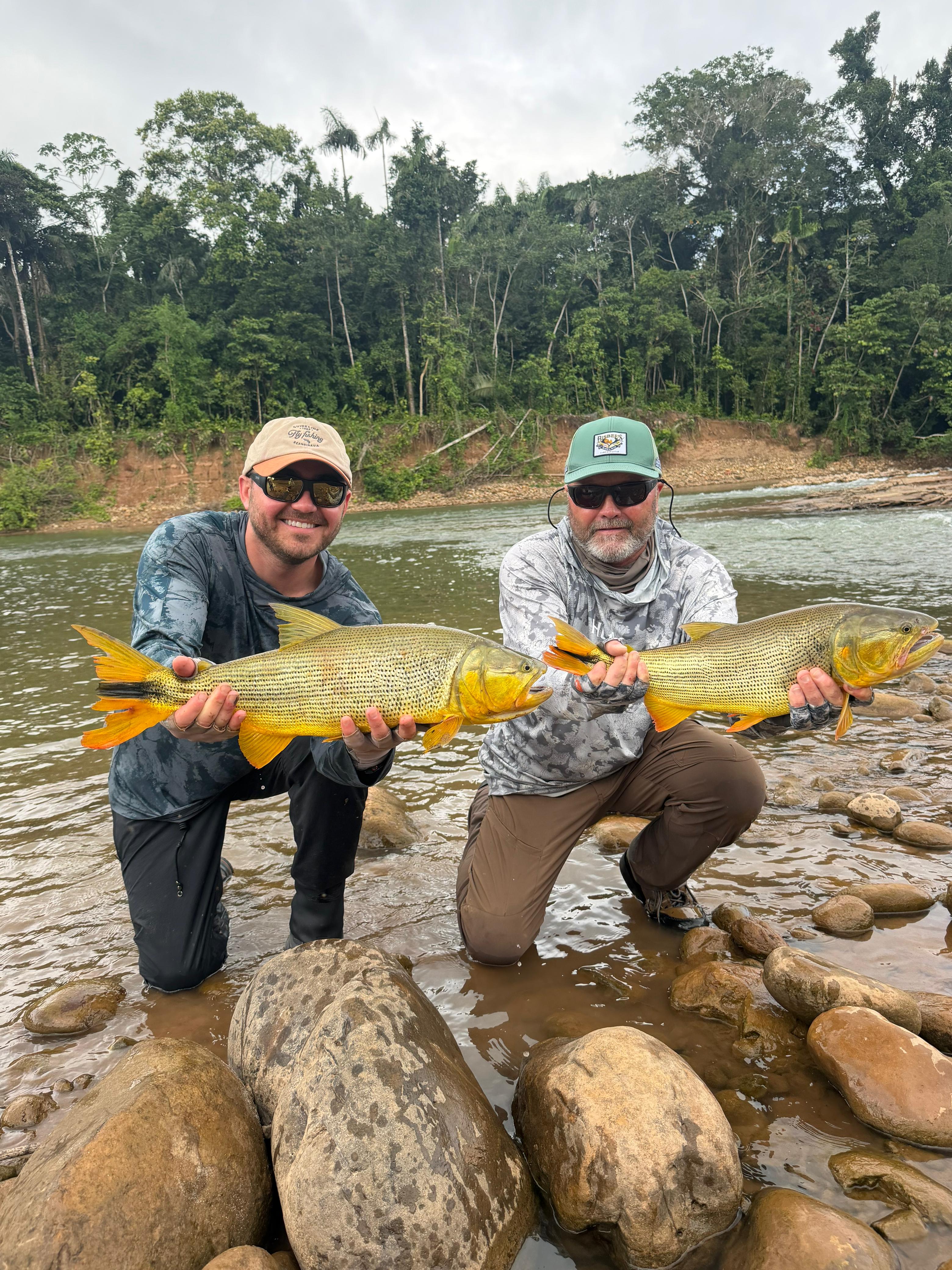 Two anglers, with a dorado for each
