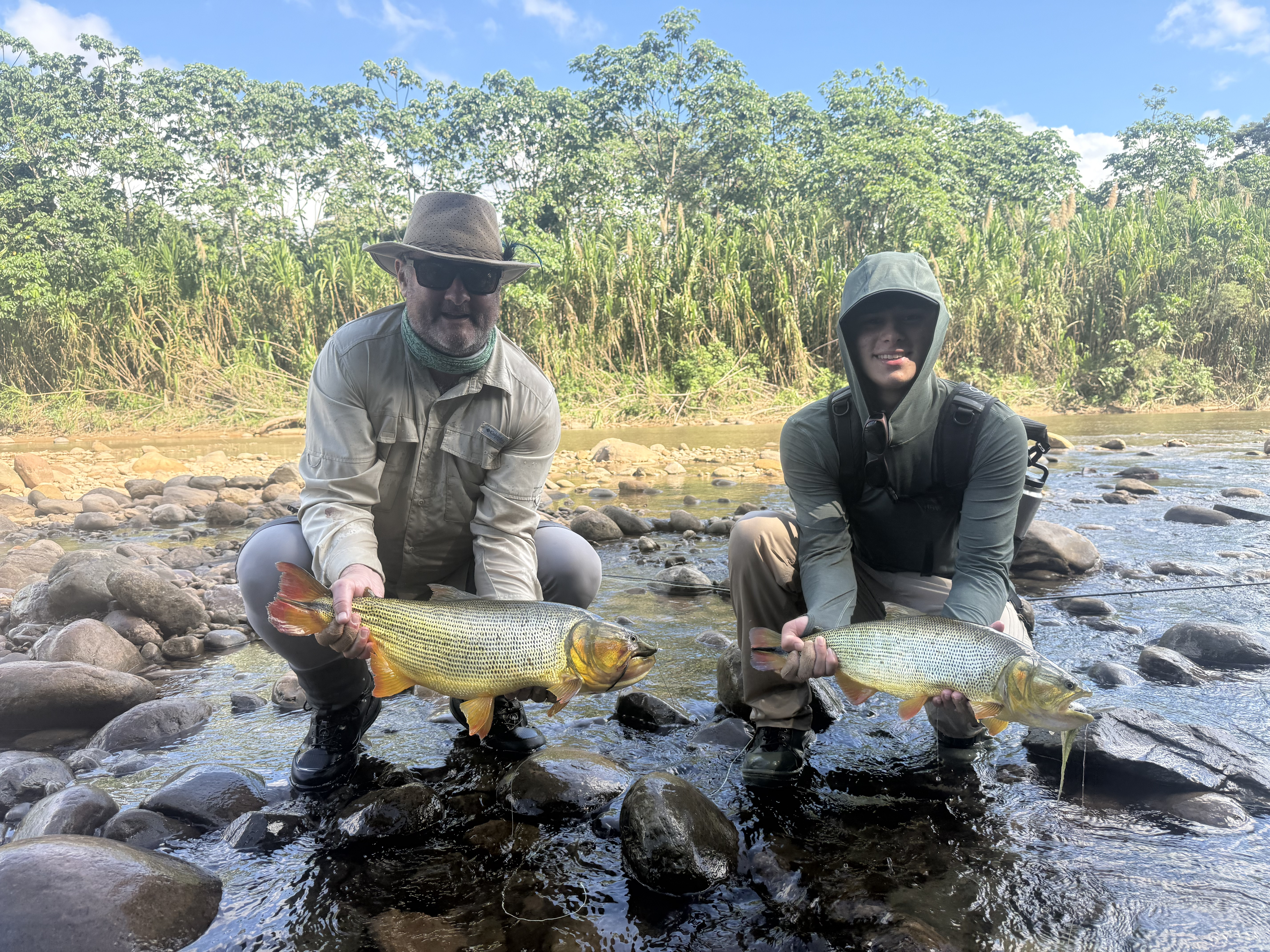 Kenneth and Alexander fishing side by side on the crystal-clear Maniquicito