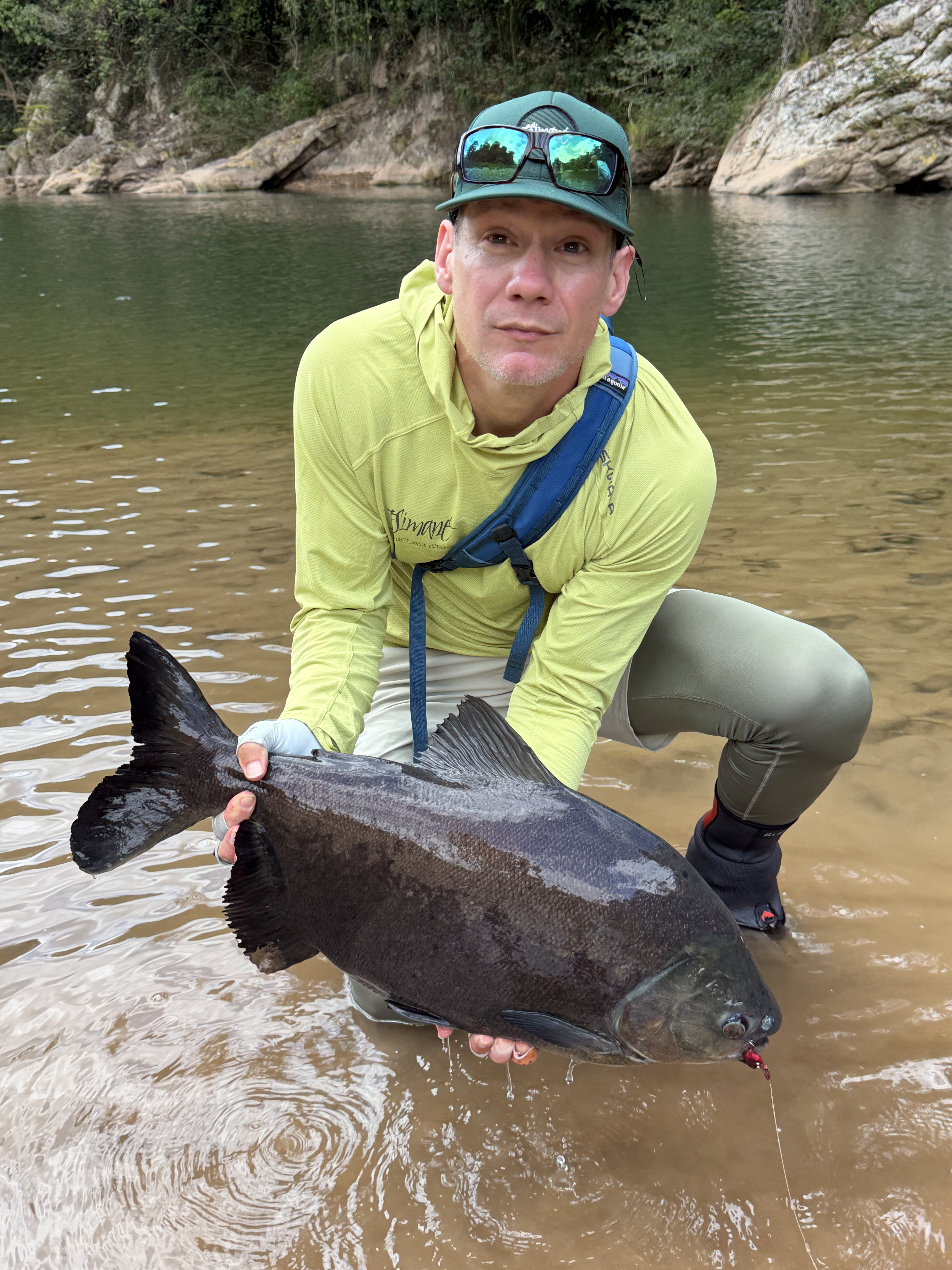 Chris with the pacú he landed on a dead drift