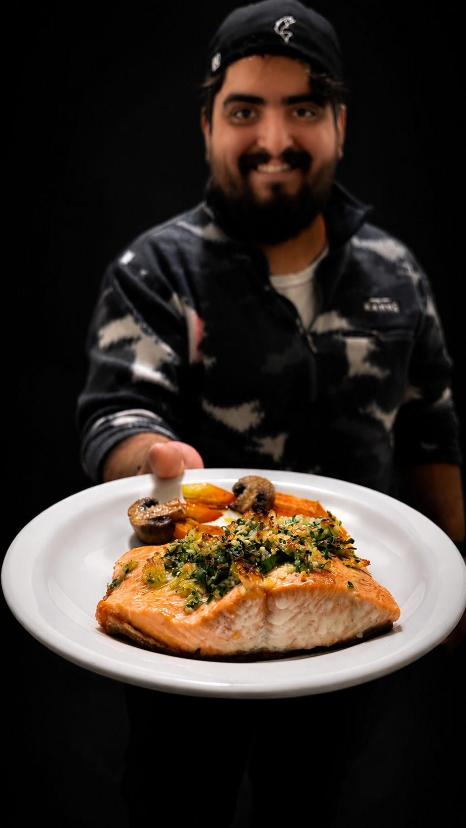 Chef Gonza presenting baked salmon