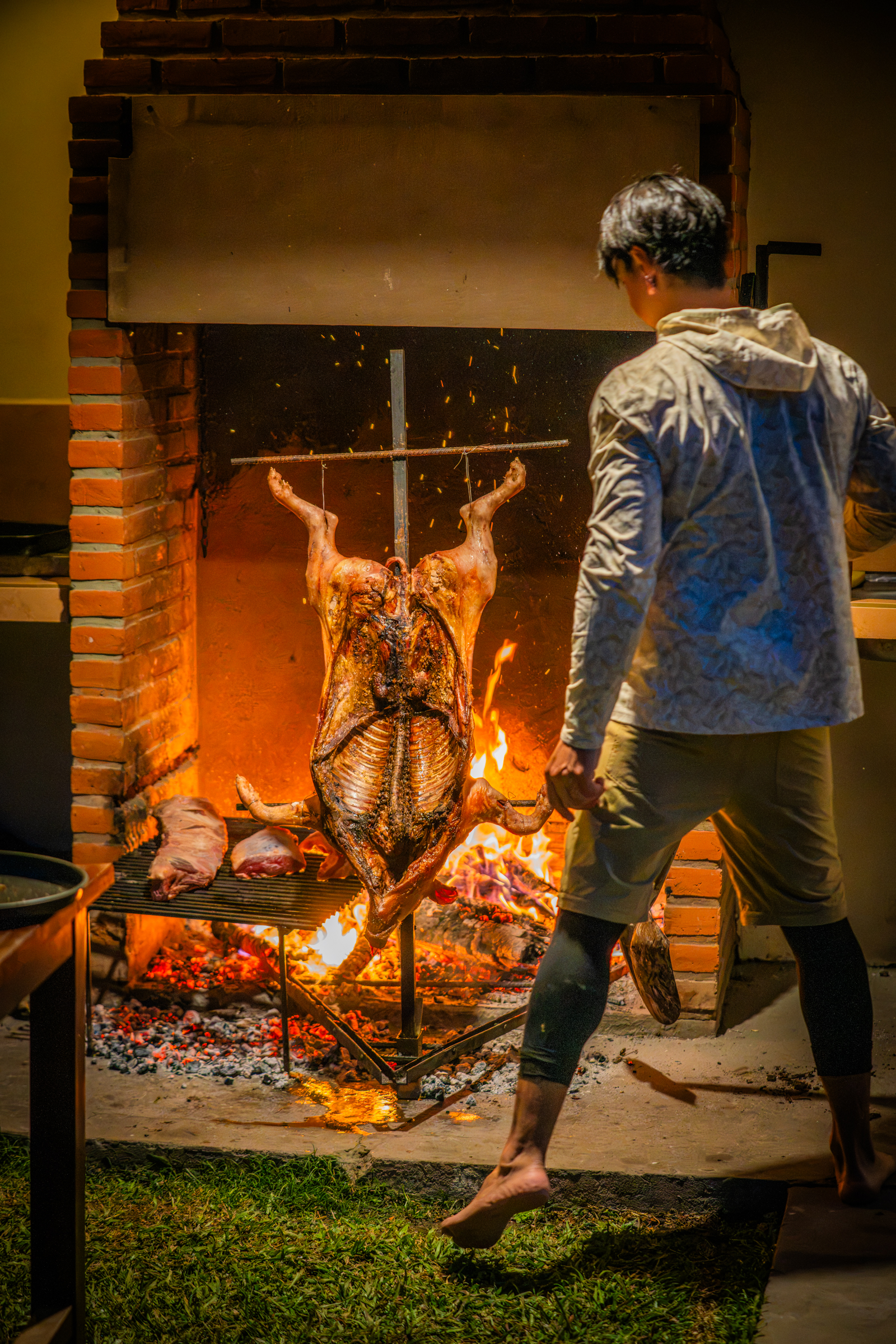 A whole pig cooking a la cruz over the open fire