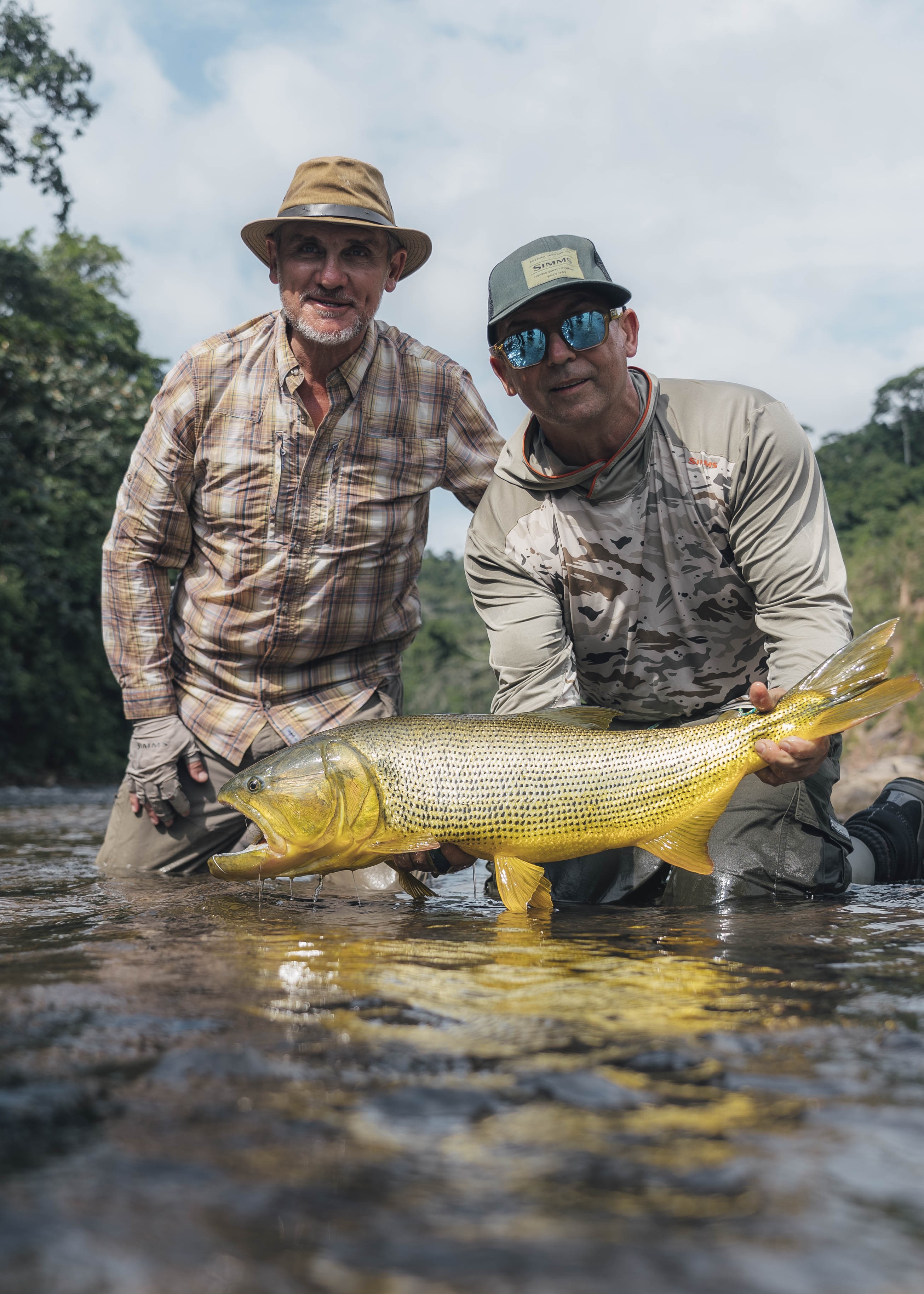 Angler with his caught Dorado joined by Jungleangler